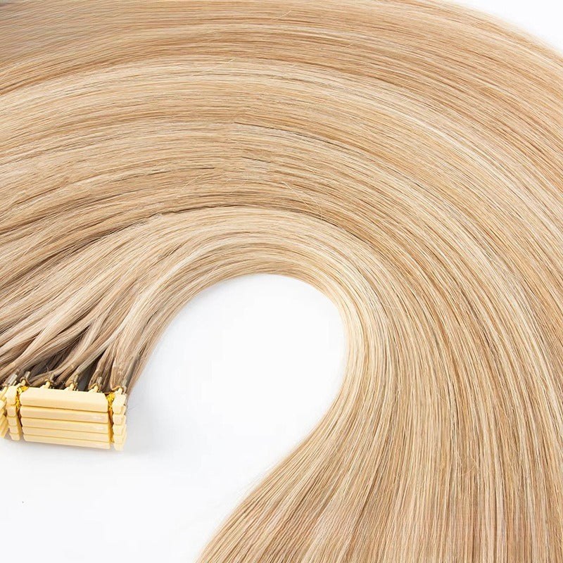 Top-down view of 6D Generation 1 straight light blonde human hair extensions with golden applicator