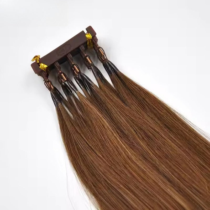Close-up of 6D applicator tool fixed on chestnut brown straight human hair extensions