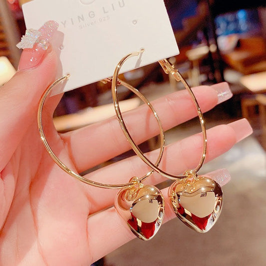 Trendy gold heart hoop earrings with hollow heart charm, minimalist metal hoops for women