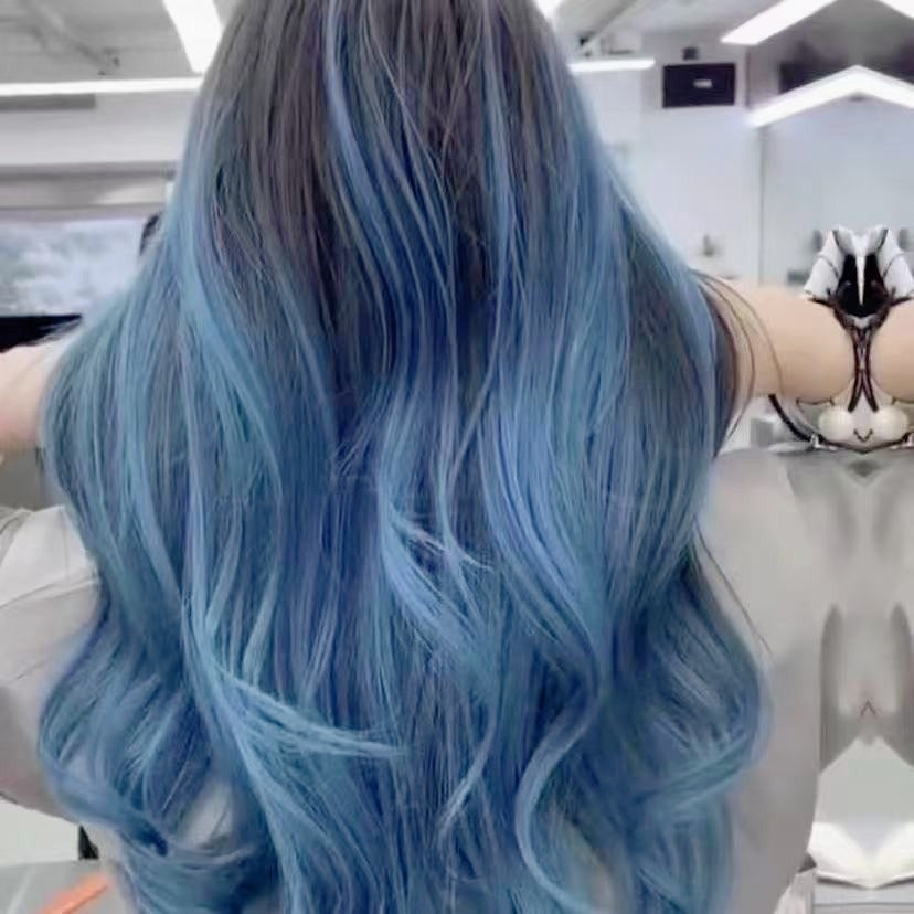Back view of blue-gray ombre feather hair extensions, showcasing a seamless, natural finish