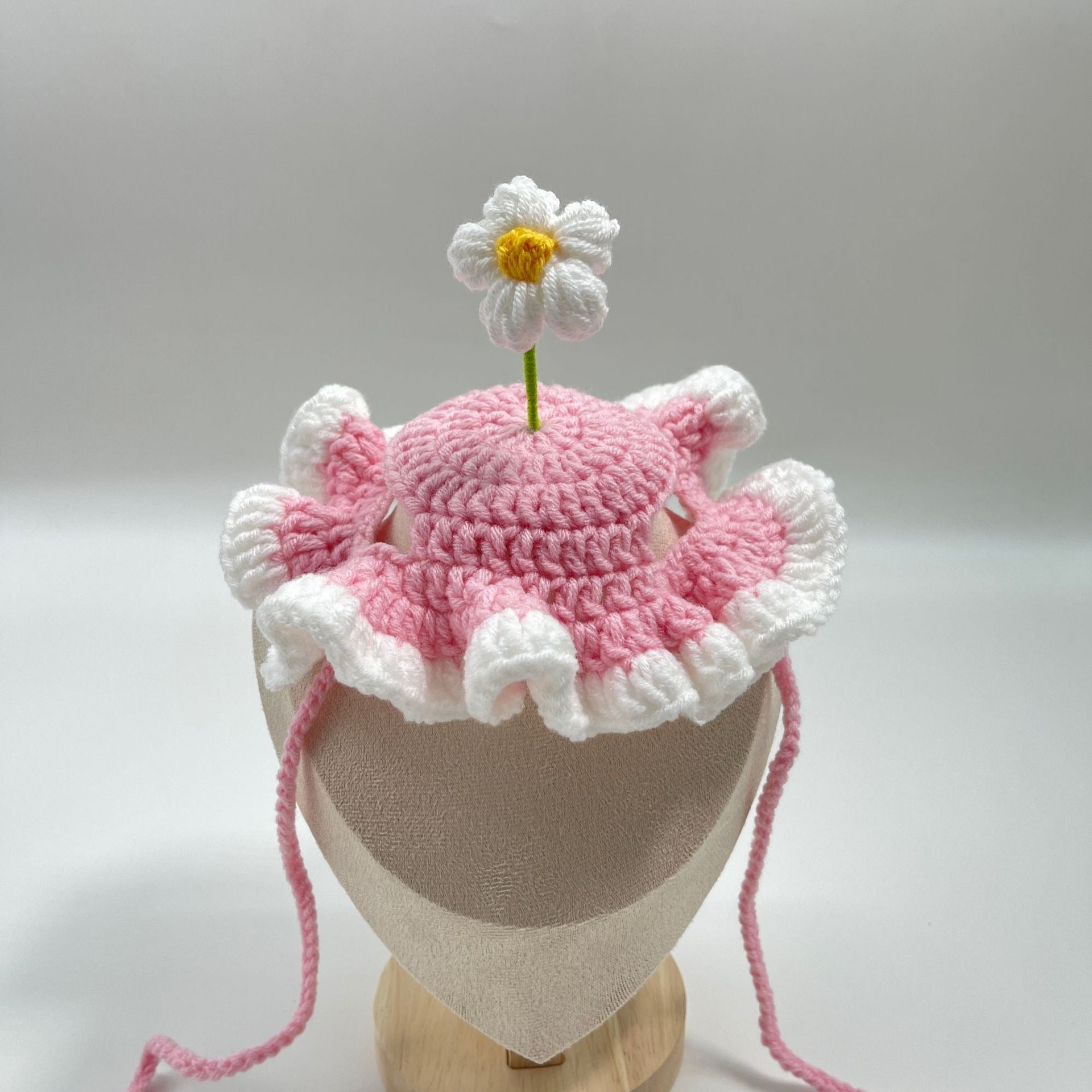 Pink pet birthday cake hat with a cake topper, displayed on a white background.