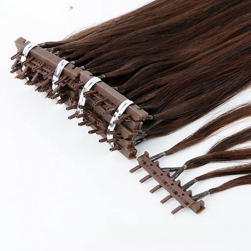 Close-up of 6D applicator tool clamping onto medium brown straight human hair extensions