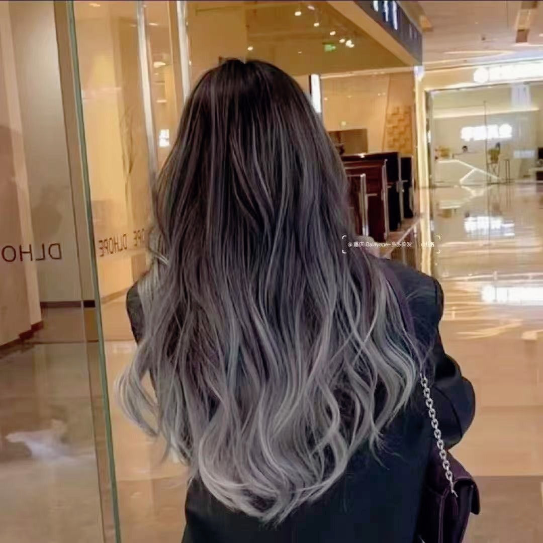 Back view of gray-pink ombre feather hair extensions, highlighting the seamless no fold head design