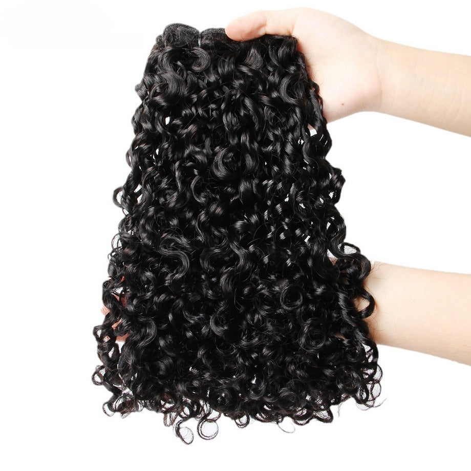 Close-up of 12A kinky curly hair being held in a hand, highlighting the thick ends and natural curl pattern.