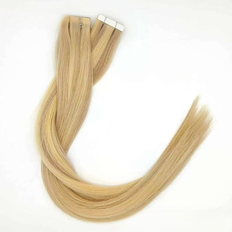 Light blonde tape-in hair extensions, coiled to show the length and soft, silky texture.
