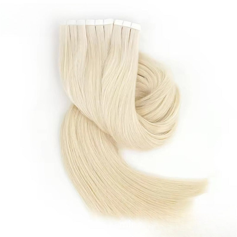 A coil of light blonde tape-in hair extensions, showing the length and silky texture.